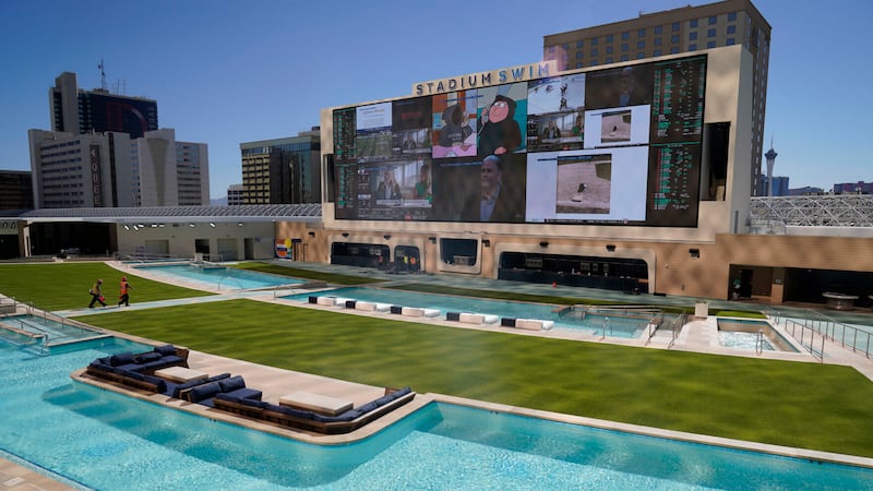 Workers walk through as they finish work at the Stadium Swim at the Circa Resort & Casino,...