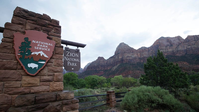 FILE - A sign hangs at Zion National Park on Tuesday, Sept. 15, 2015, near Springdale, Utah. A...