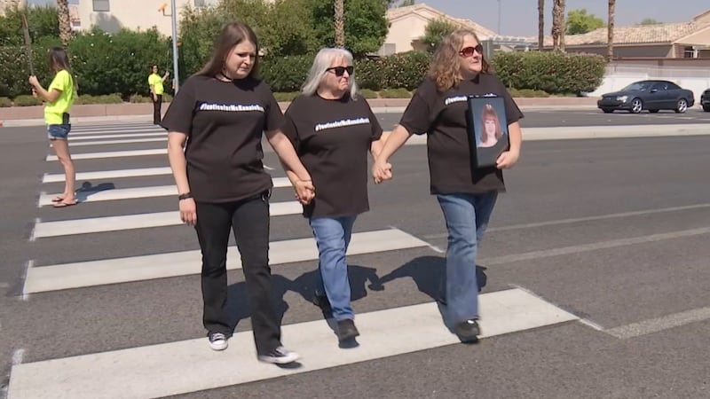 A grieving family bravely walked along the crosswalk outside Arbor View High School where...