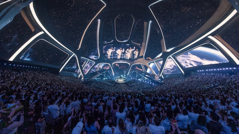 The Backstreet Boys perform beneath a sprawling starfield display at Sphere, as thousands of...