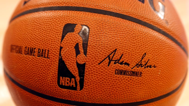 FILE - An NBA logo is seen on an official game ball before a basketball game, Feb. 1, 2014, in...