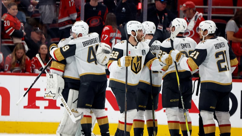 Vegas Golden Knights congratulate goaltender Carter Hart following Game 1 of the NHL hockey...