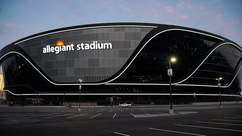 Lights adorn Allegiant Stadium, new home of the Las Vegas Raiders football team, as it nears...