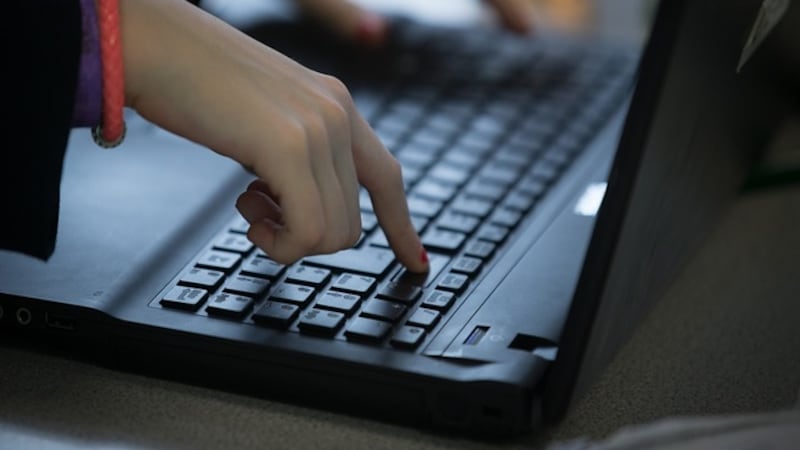 BRISTOL, UNITED KINGDOM - FEBRUARY 26: A pupil uses a laptop computer during a english lesson...