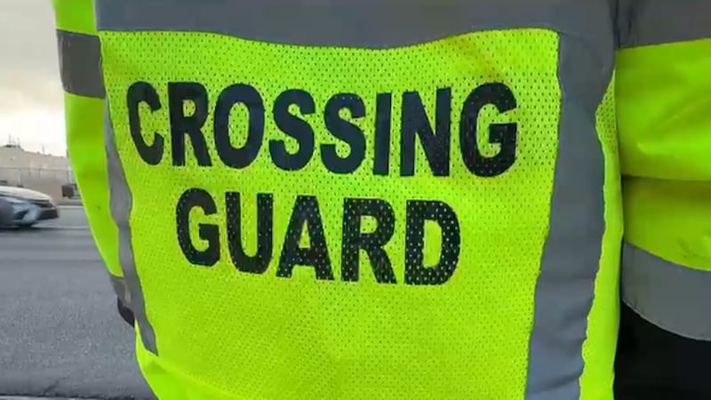 A school crossing guard was hospitalized Wednesday morning after being struck by a hit-and-run...