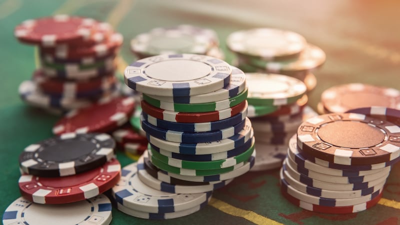 Casino poker chips on green felt background. All for success game.