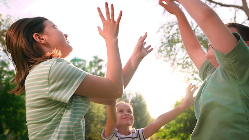 Happy children playing playground, children hands sun glare nature, boy girl friends...