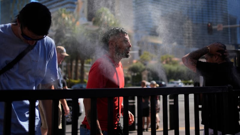 People cool off in misters along the Las Vegas Strip, Sunday, July 7, 2024, in Las Vegas. Used...